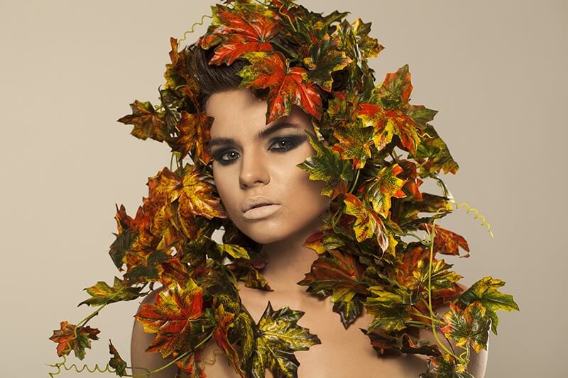 woman covered in leaves 