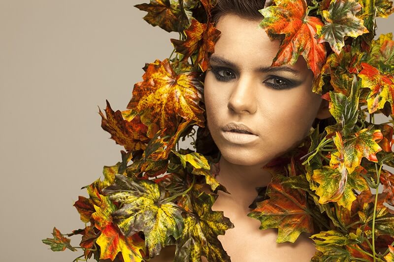 woman covered in leaves 