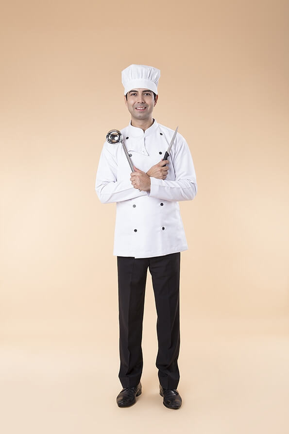 chef posing with knife and ladle