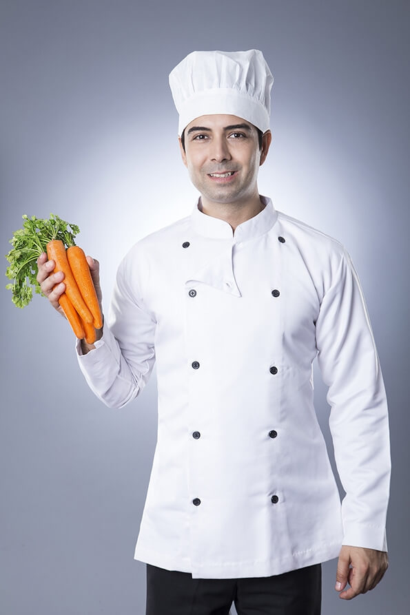 chef posing with fresh carrots 