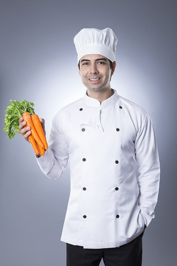 chef posing with fresh carrots 