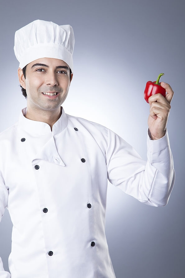 chef posing with red capsicum