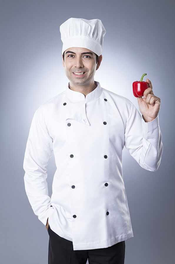 chef posing with red capsicum