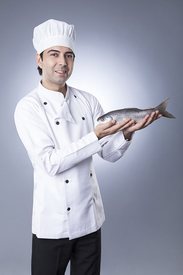 chef posing with fish 