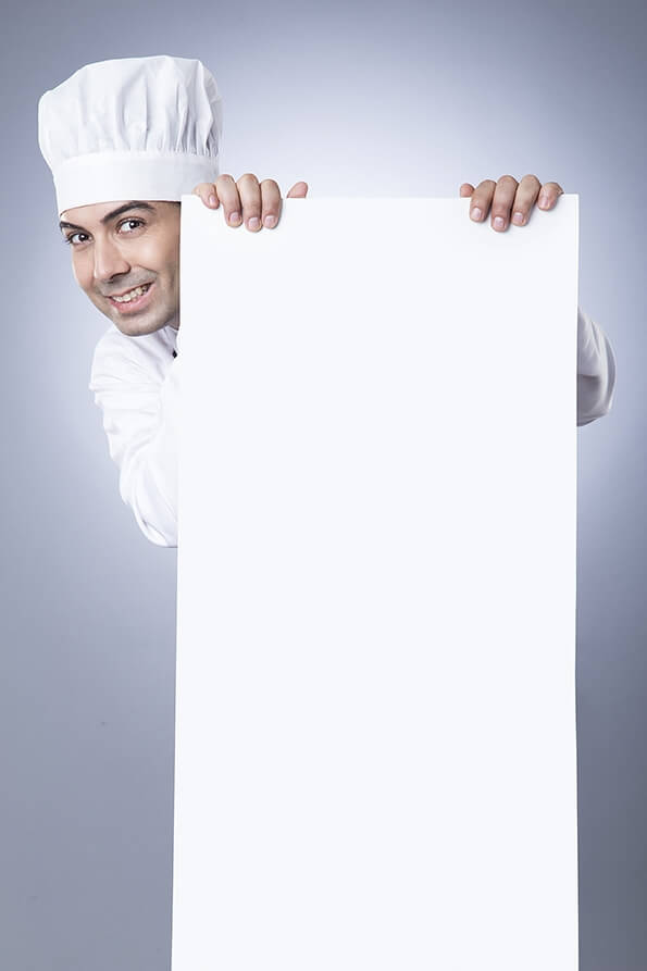 chef posing with placard