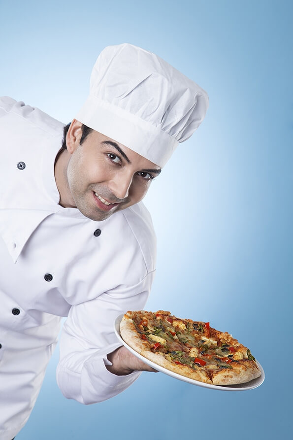 chef posing with pizza