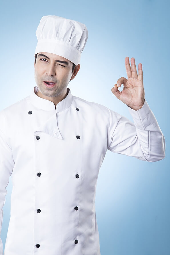 chef winking and gesturing while posing