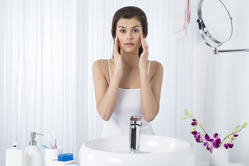 woman applying moisturiser