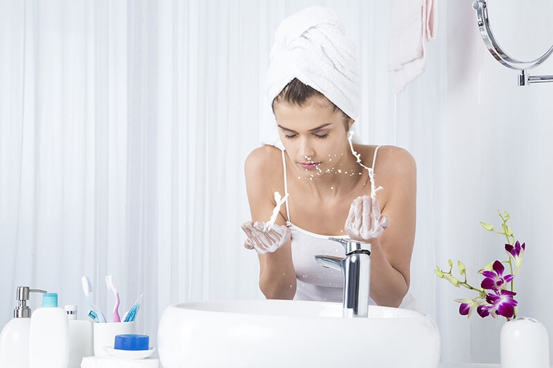 woman applying face wash