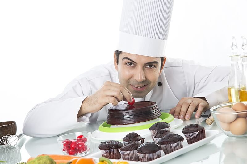  chef with cake and muffins 