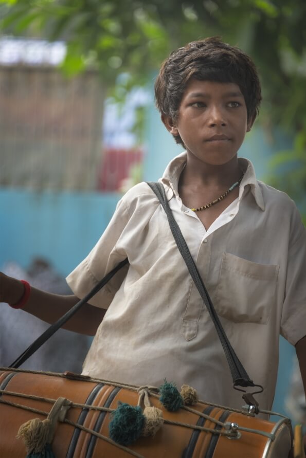 innocent street kid playing dhol