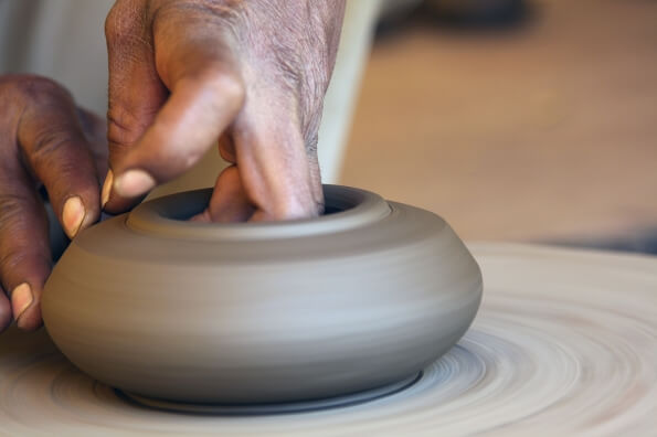 potter working on pot wheel