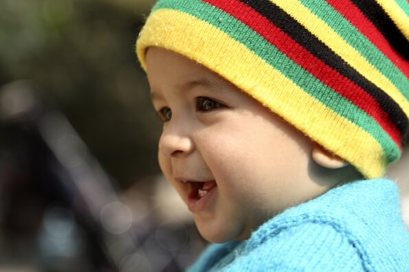 infant in winter wear smiling 