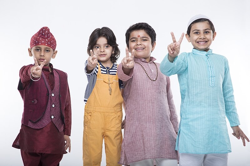 kids from different religions showing peace symbol 
