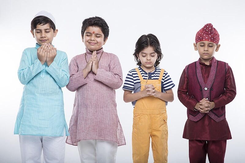 kids from different religions praying with folded hands