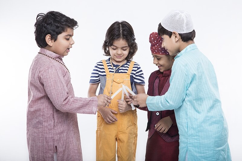 kids from different religion praying with candles