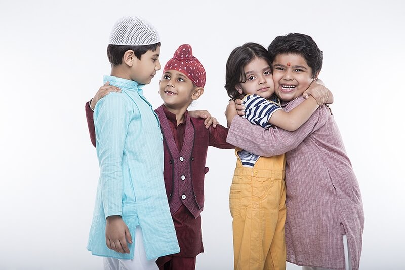 kids from different religions hugging each other 