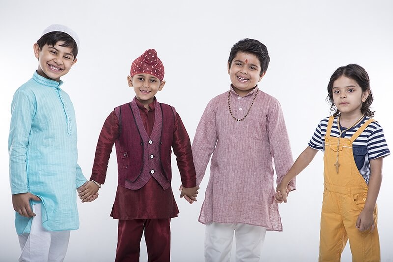 kids from different religions holding each others hands 