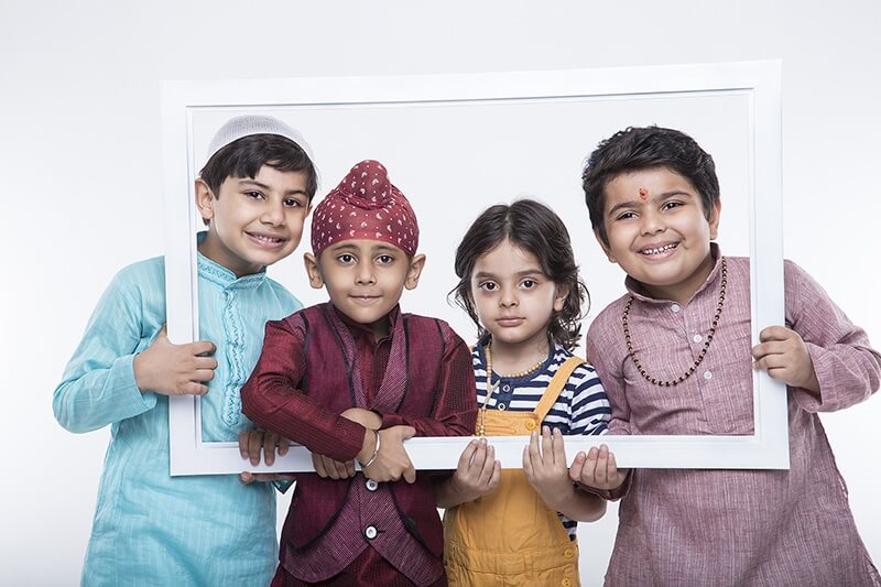 kids from different religions posing from a frame 