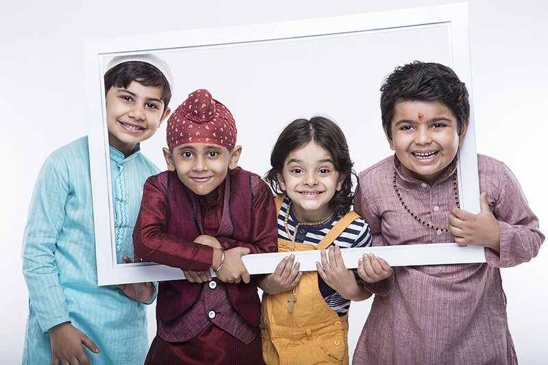 kids from different religions posing from a frame 