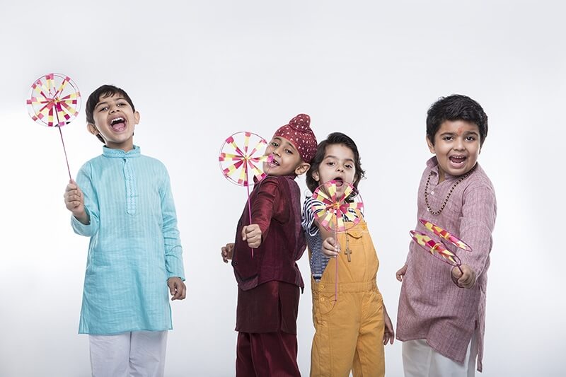 kids from different religions with windmill toy
