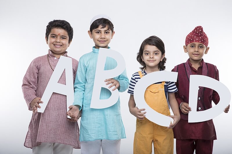 kids posing with alphabets