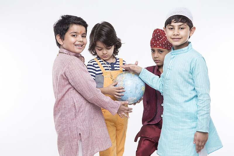 four kids carrying globe while posing