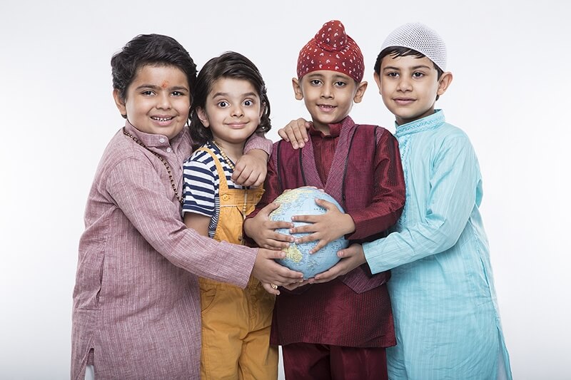 four kids carrying globe while posing