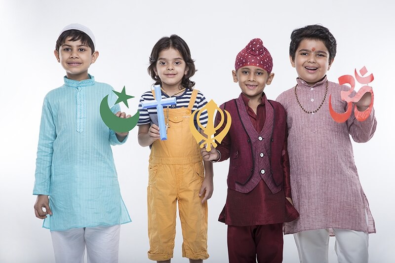 four kids posing with religious symbols