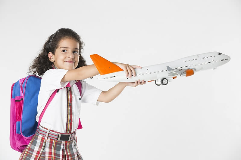 school kid playing with aeroplane miniature