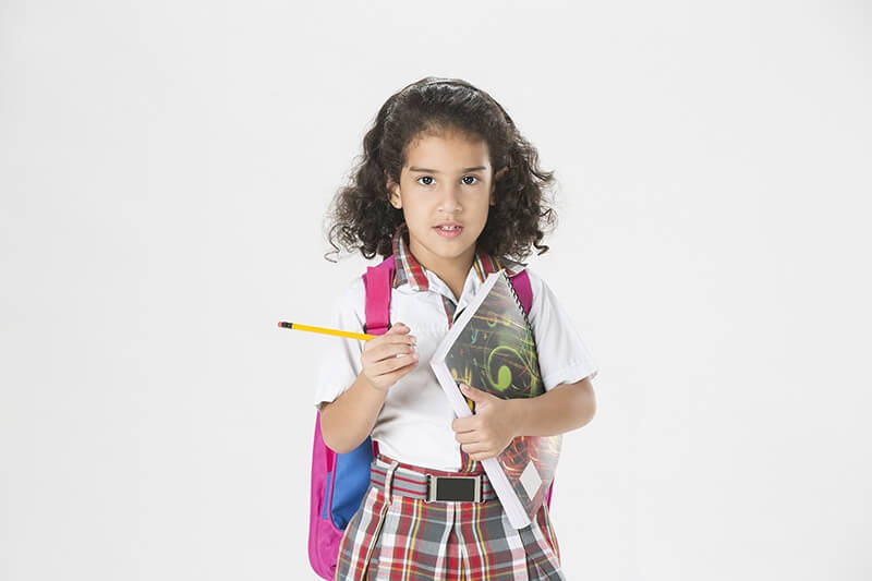 girl in school uniform with notebook and pencil 