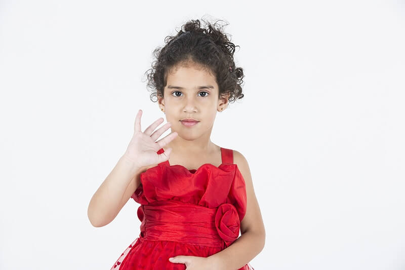 girl wearing red dress gesturing