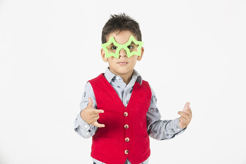 boy wearing colourful glasses  