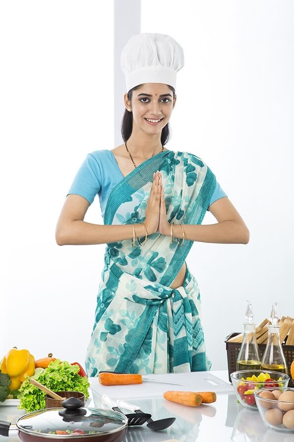 Indian housewife greeting in kitchen 
