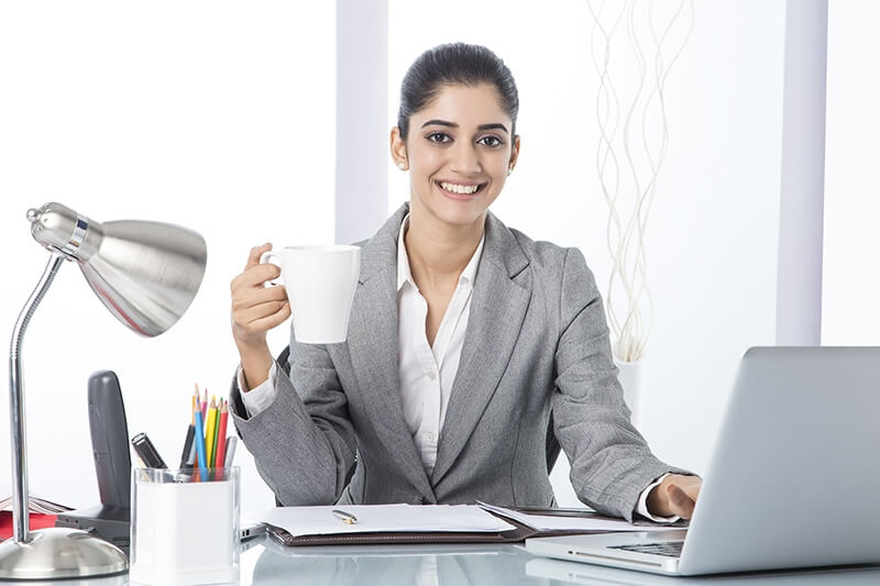 corporate woman having coffee while working 