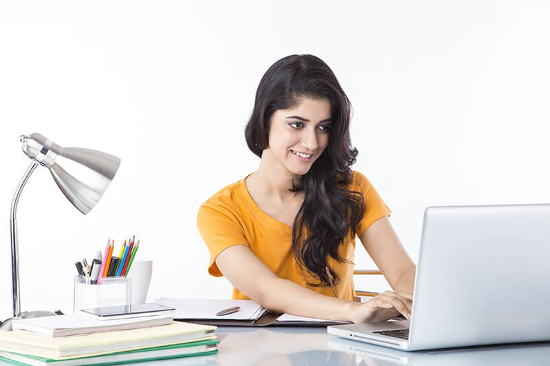 woman sitting and working on laptop 