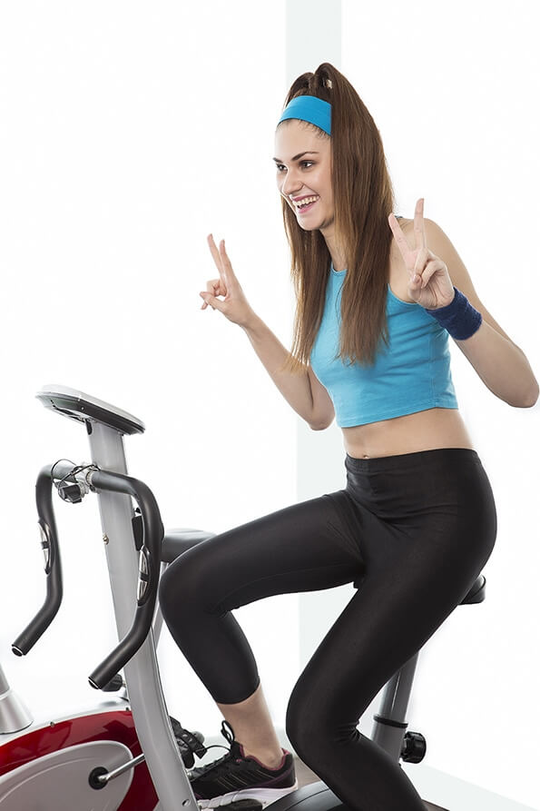 girl in gym cycling