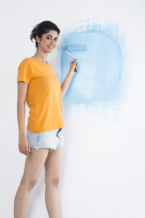 woman painting her wall 