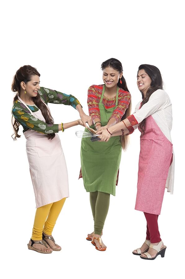 women wearing apron with kitchen utensils