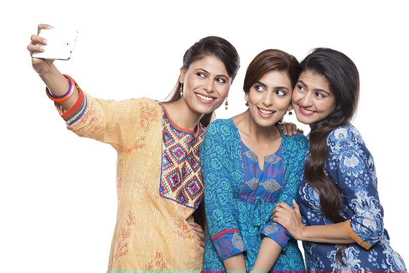 three women taking selfie on phone