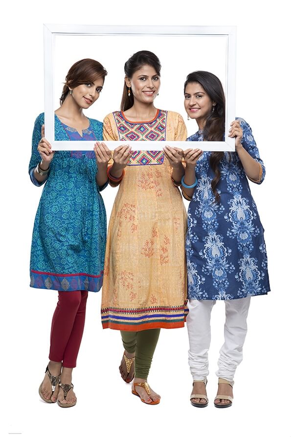 Three stylish woman looking through a frame