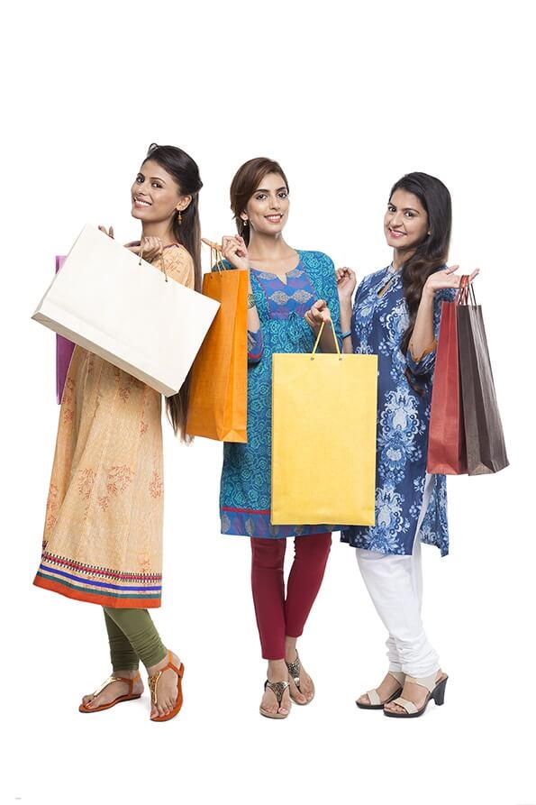 Three Indian women with shopping bags