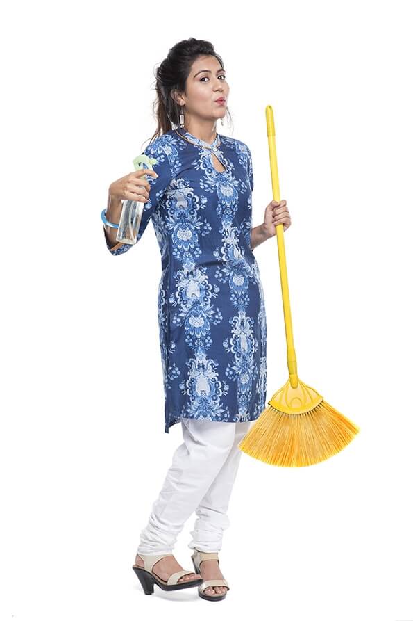 woman holding mop duster and grass broom
