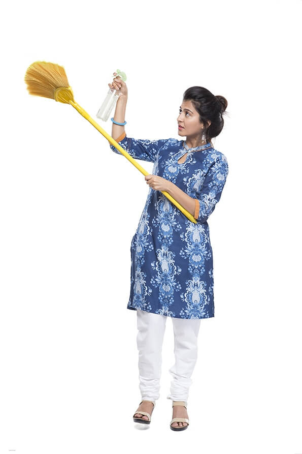 woman holding mop duster and grass broom