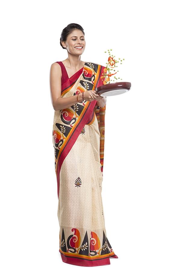 women wearing saree and tossing vegetables in fry pan