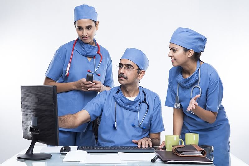 doctor and nurse using computer in meeting