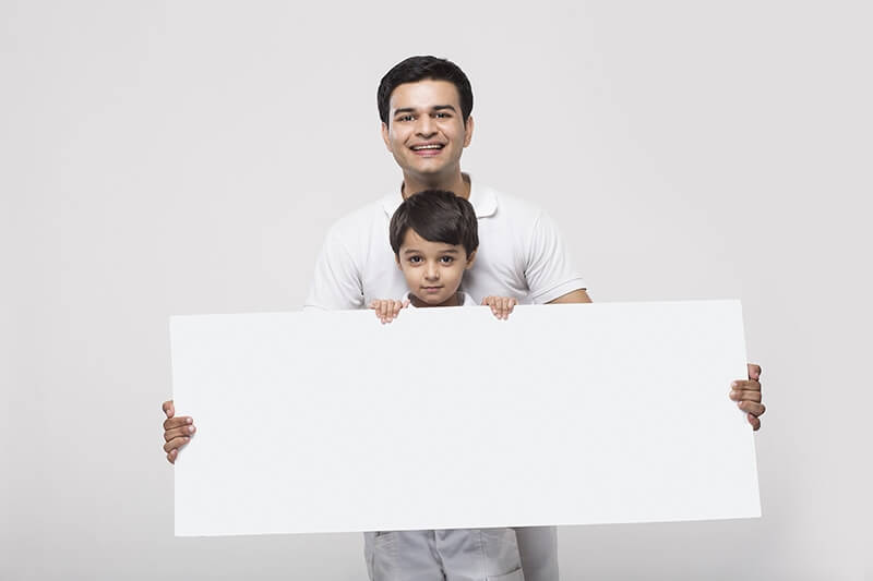 father & son holding blank placard in same clothes