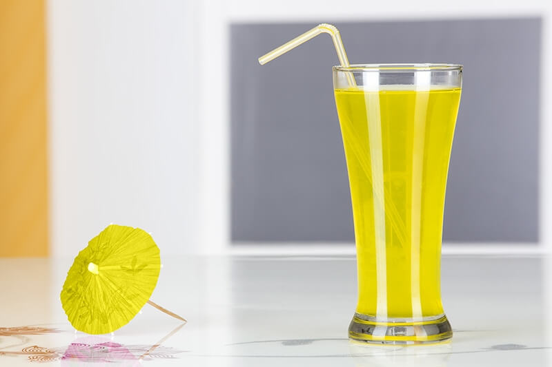 juice in glass straw and small umbrella on it