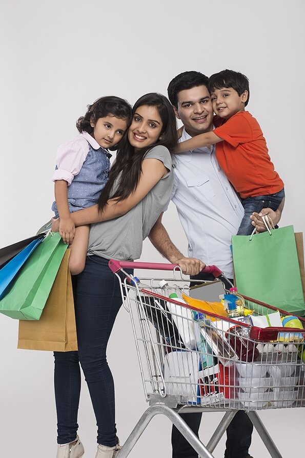 Indian family posing with shopping cart