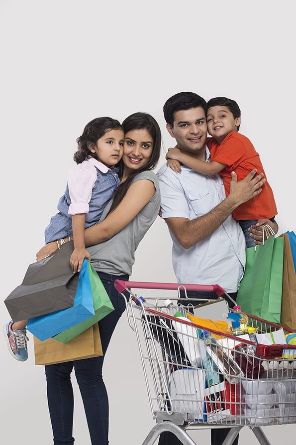 Indian family posing with shopping cart